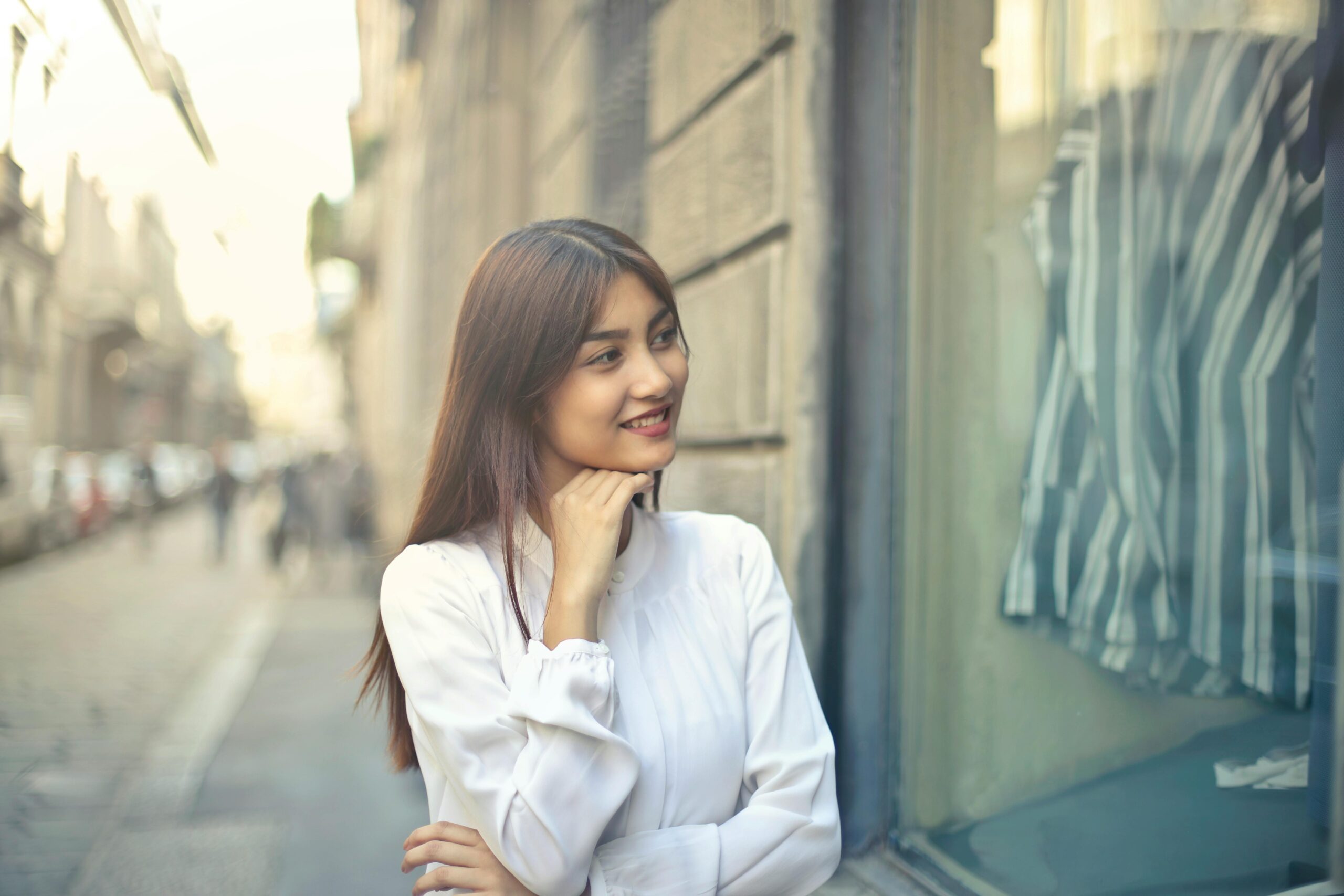 Young woman enjoying a sunny day shopping in Milan, Italy.